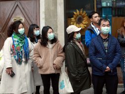 People wear protective masks at Venice Carnival, which the last two days of, as well as Sunday night’s festivities, have been cancelled because of an outbreak of coronavirus, in Venice
