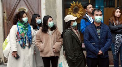 People wear protective masks at Venice Carnival, which the last two days of, as well as Sunday night’s festivities, have been cancelled because of an outbreak of coronavirus, in Venice