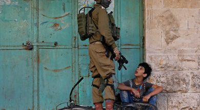 An Israeli soldier detains a Palestinian boy during an anti-Israel protest in Hebron in the Israeli-occupied West Bank